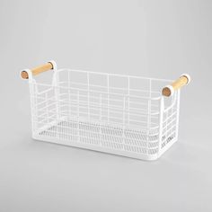 a white plastic basket with wooden handles