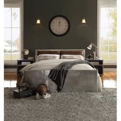 a bedroom with a large clock on the wall next to a bed and two nightstands