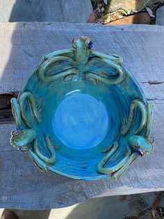 a blue bowl sitting on top of a wooden table