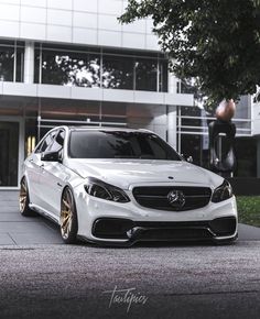 a white car parked in front of a building