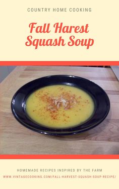 a black plate topped with soup on top of a wooden table