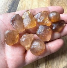 some brown and yellow rocks in someone's hand