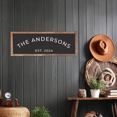 there is a sign that says the andersons est 2094 next to a hat rack