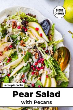 pear salad with pecans and pomegranates on a white platter