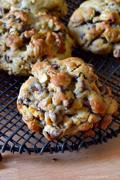 chocolate chip cookies on a cooling rack with one cookie broken in half to the side