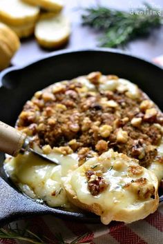 a cast iron skillet filled with cheese and meat