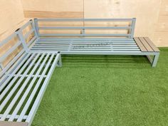 a metal bed frame sitting on top of green carpeted floor next to a wooden wall