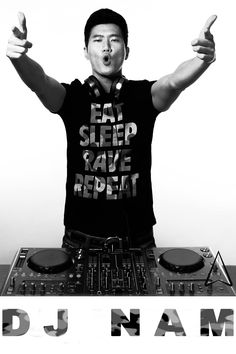 a man with his hands up in front of a dj's turntable and headphones