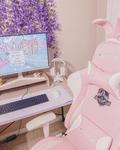 a pink computer chair sitting in front of a monitor