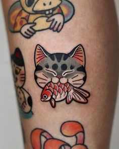 a close up of a person's legs with tattoos on them and cats in the background