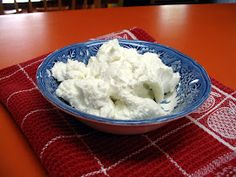 a bowl filled with cottage cheese on top of a table