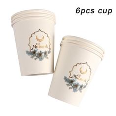 two white cups with blue flowers on them