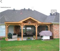 an outdoor covered patio with grill and bbq