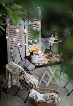 an outdoor table and chair with food on it