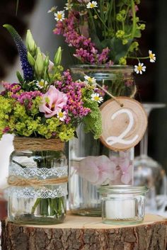 flowers are in mason jars on top of a tree stump with the words, wedding decoration vintage horchet aur