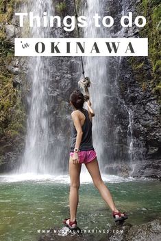 a woman standing in front of a waterfall with the words things to do in oknawa