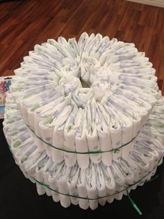 a stack of toilet paper sitting on top of a wooden floor