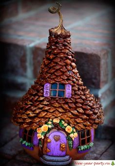 a small house made out of pine cones