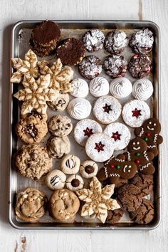 a metal tray filled with lots of different types of cookies