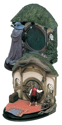 a figurine is standing in front of a small house with a green door