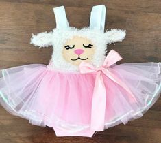 a stuffed animal wearing a pink tutu skirt