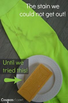 a piece of yellow soap sitting on top of a white plate next to a green jacket