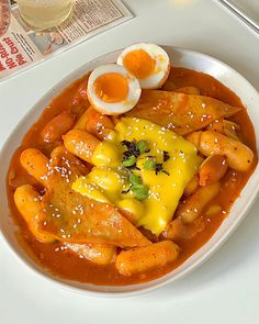 a white plate topped with food and an egg