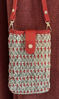 a crocheted bag hanging from the back of a woman's shoulderbag