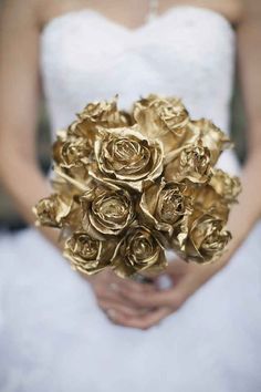 a woman holding a bouquet of gold roses in her hands with the caption, 26 likes lovelyweddings golden roses need we say more?