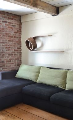 a living room with a couch, coffee table and brick wall in the back ground