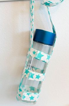 a water bottle hanging from a hook on the wall