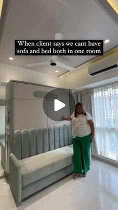 a woman standing next to a bed in a room