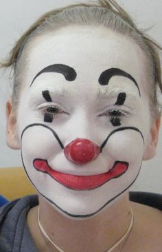 a woman wearing a clown mask with her hair in pigtails and nose piercings