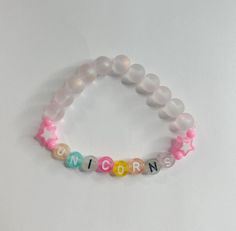 Unicorn bracelet made of iridescent glass beads, colored letters, star beads, pink spacer beads, and stretchy elastic. Unicorn Bracelet, Spacer Beads, Bracelet Making, Favorite Jewelry, Glass Beads, Jewelry Bracelets, Beauty Book, Beaded Bracelets, Accessory Gift