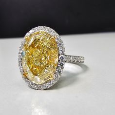 6.16 carat center Fancy Light Yellow Diamond Oval Cut VS1 Clarity GIA Certified Diamond Excellent + Very Good cutting Surrounded by 0.69 Carats of White Diamonds Set in Platinum & 18k Handmade in NYC Ready to Ship Oval Canary Yellow Diamond Ring, Oval Yellow Diamond Ring, 12 Carat Diamond Ring, Oval Yellow Diamond Engagement Ring, Canary Diamond Engagement Ring, Yellow Sapphire Engagement Ring, Dig Jewelry, Yellow Sapphire Ring Engagement, Oval Halo Diamond Ring