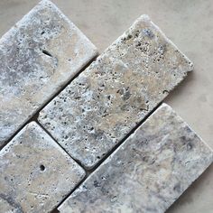 four square white marble tiles laid on top of each other