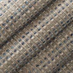 an upholstered fabric with blue and white squares on it, in neutral colors