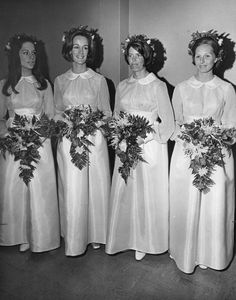 black and white photograph of bridesmaids in long dresses with flowers on their heads