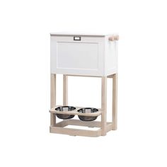 an elevated dog food station with two bowls on the bottom and one drawer open to allow water