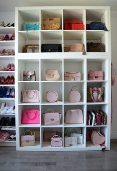 a closet filled with lots of different types of purses and handbags on shelves