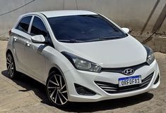 a white car parked in front of a building