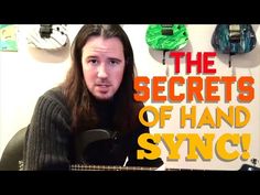 a man with long hair holding a guitar in front of his face and text that reads, the secrets of hand sync