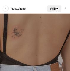 the back of a woman's stomach with two small tattoos on her left side