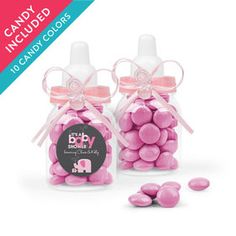 two bottles filled with pink candy candies next to each other on a white background