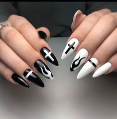 two hands with black and white nail designs