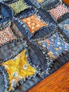 an old patchwork quilt with many different colored patches on the front and back of it