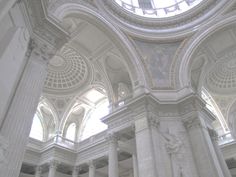 the inside of a building with columns and arches