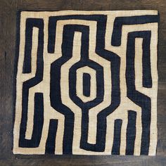 a black and white rug on a wooden floor