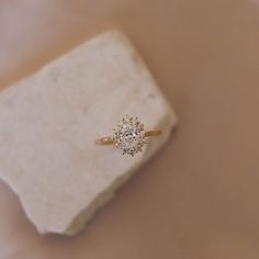 a diamond ring sitting on top of a rock