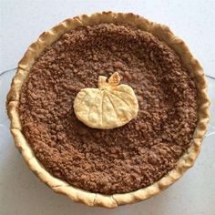 a pie with a piece of pumpkin sitting on top of it's bottom crust